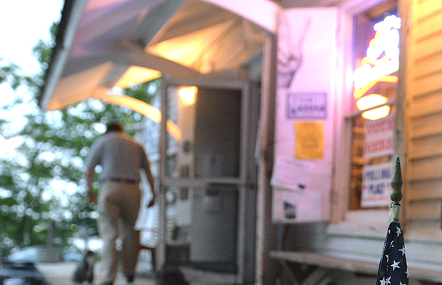 A lone voter exits the polls after casting his vote early, May 20, 2014, at the Rabbit Hash General Store in Rabbit Hash, Kentucky. (AP/Timothy D. Easley)