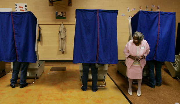 Poll volunteer Ethel Dunson waits for voters to finish casting their ballots in Columbus, Ohio. (AP/Laura Rauch)