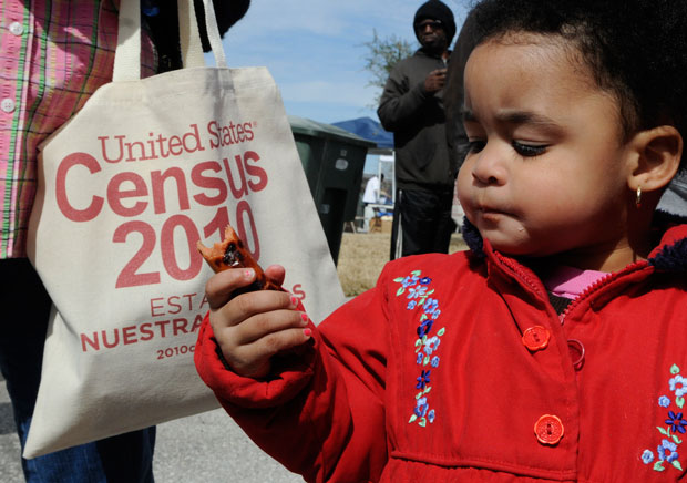 K'Treana Taylor, 2, eats a hot dog at a community resource fair in Galveston, Texas, to explain the importance of participating in the 2010 Census. (AP/Pat Sullivan)
