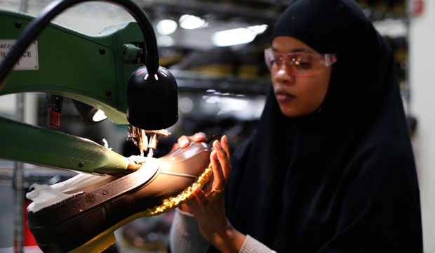 Muslima Hassan trims the rubber bottom of an L.L. Bean boot at a facility in Lewiston, Maine. (AP/Robert F. Bukaty)