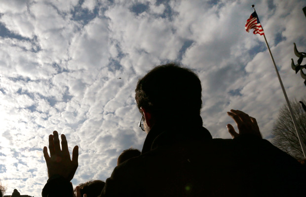 A demonstrator holds his hands up on campus at Boston University during a protest to show solidarity with protesters in Ferguson, Missouri. (AP/Elise Amendola)