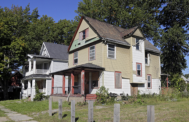 Aluminum siding has been stripped from an abandoned home in East Cleveland, Ohio, September 24, 2014. (AP/Mark Duncan)