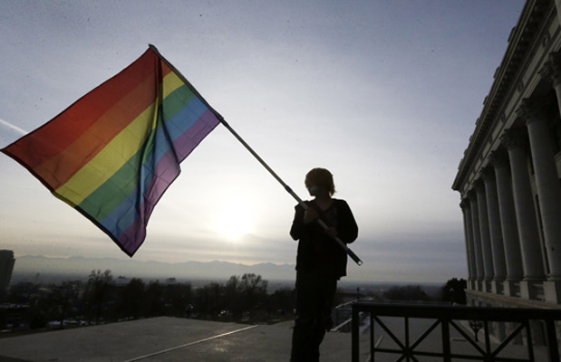 Corbin Aoyagi, a supporter of gay marriage, waves his flag during a rally at the Utah State Capitol, Tuesday, January 28, 2014. (AP/Rick Bowmer)