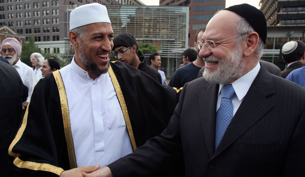 Sheikh Imam Mohammed Shchata and Rabbi Albert Gabbi talk during a public assembly for religious tolerance in Philadelphia. (AP/Joseph Kaczmarek)