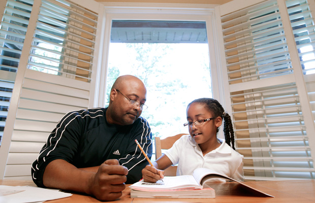 Roger Witherspoon helps his daughter with her homework in Nashville, Tennessee. (AP/Mark Humphrey)