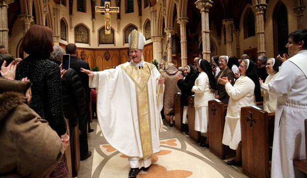 Archbishop Blase Cupich walks down the aisle after his installation Mass at Chicago's Holy Name Cathedral on November 18, 2014. (AP/Charles Rex Arbogast)