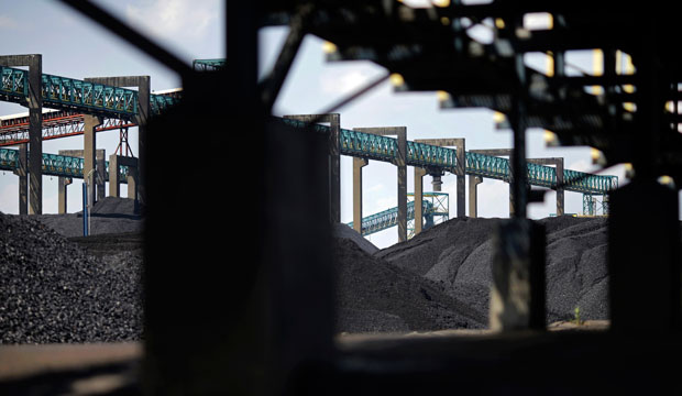 Piles of coal sit below conveyor belts at the Dominion Terminal Associates coal terminal, front, and Kinder Morgan coal terminal, back, in Newport News, Virginia. (AP/Patrick Semansky)