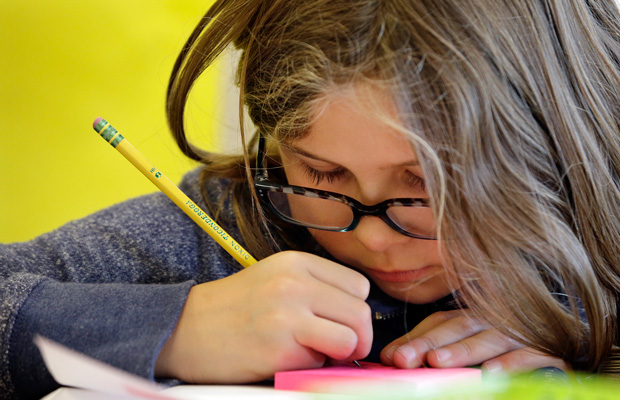 A fifth grader works on a project in her classroom at John Hay Elementary school in Seattle. (AP/Elaine Thompson)