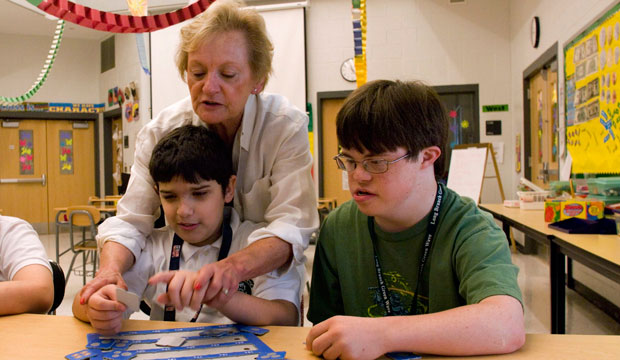 Special education teacher Karen Hansen works with students during a money counting exercise at Long Branch Middle School in Long Branch, New Jersey. (AP/Colin Archer)