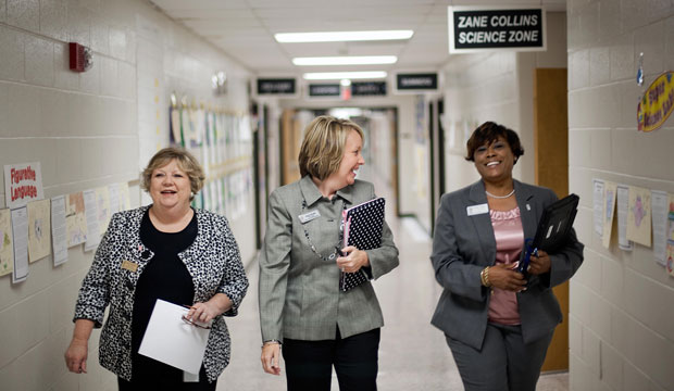 Gloria Thomas, right, an aspiring principal in residency walks through the halls with principal Angie Pacholke, center, and Karen Robinson, a leader mentor, at Rock Springs Elementary school, in Lawrenceville, Georgia. (AP/David Goldman)