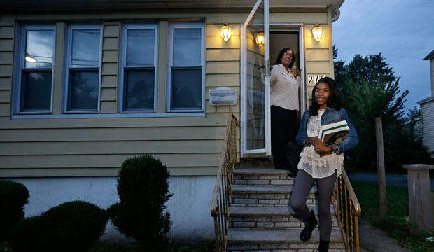 Tysha Wheeler-Timmons watches from the doorway as her daughter Shayla leaves for school in Rahway, New Jersey. (AP/Mel Evans)