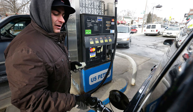 Justin Zahreddine, of Quincy, Massachusetts, fuels up at a gas station where regular unleaded was listed for a cash price of $1.99 per gallon, Jan. 7, 2015, in Boston. (AP/Steven Senne)