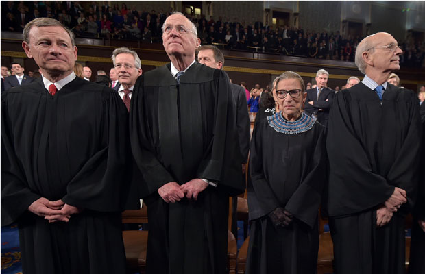 U.S. Supreme Court Chief Justice John G. Roberts and justices Anthony M. Kennedy, Ruth Bader Ginsburg, and Stephen G. Breyer stand before President Barack Obama's State of the Union address on January 20, 2015. (AP/Mandel Ngan)