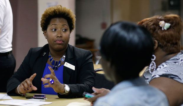 Natalie Parker talks with applicants during a job fair at the Hospitality Institute. (AP/Lynne Sladky)