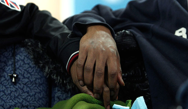 Two boys hold hands at the Ruth Ellis Center, a drop-in shelter for LGBT youth in Detroit, March 2012. (AP/Paul Sancya)