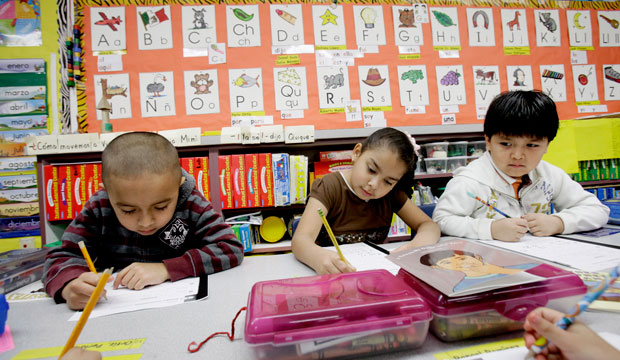Five-year-old kindergarden students Gael Alvarado, left, Perla Ortiz, center, and Yahir Perez do school work in a bilingual English-Spanish class at Hanby Elementary School in Mesquite, Texas, in 2011. (AP/LM Otero)
