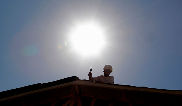 A roofer works under the midday sun in Gilbert, Arizona, in July 2014. (AP/File)