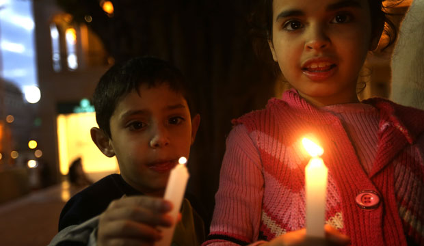 Children hold candles during a vigil in downtown Beirut, Lebanon, on March 1, 2015, held in solidarity with Christians abducted in Syria and Iraq. (AP/Hussein Malla)