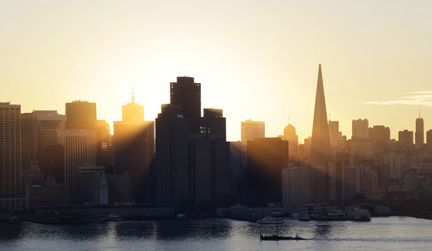 The sun sets behind the city skyline on January 7, 2015, in San Francisco. (AP/Marcio Jose Sanchez)
