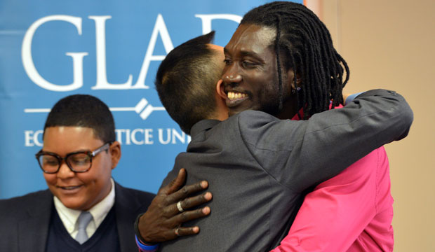 Ugandan gay rights activist John Abdallah Wambere, right, embraces attorney Janson Wu at the end of a news conference on May 6, 2014, in Boston. Wambere is seeking asylum in the United States to escape persecution in his home country. (AP/Josh Reynolds)