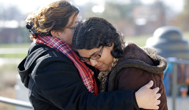Ella Mendoza, right, and Raymi Gutierrez hug during a news conference with activists and members of immigrant families in Salt Lake City, Utah, on November 21, 2014. (AP/Rick Bowmer)