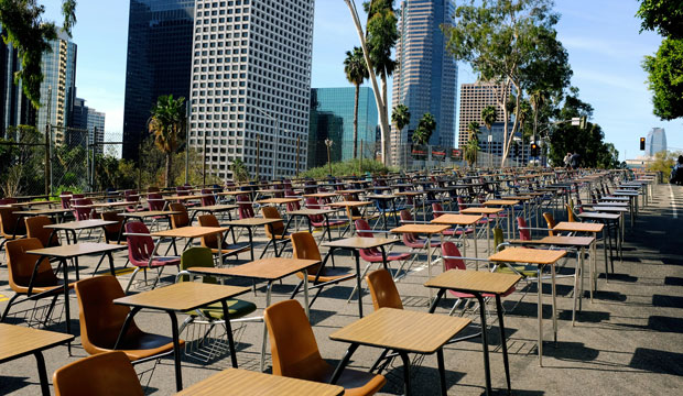 School desks block a street in front of the Los Angeles Unified School District headquarters in a demonstration against student dropout rates on April 8, 2014, in downtown Los Angeles. (AP/Richard Vogel)