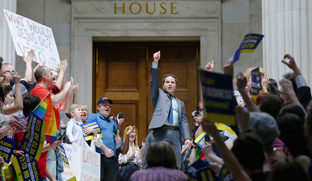 Rep. Warwick Sabin (D) cheers with protesters outside the House chamber at the Arkansas State Capitol in Little Rock after a House committee advanced H.B. 1228, a bill similar to Indiana’s Religious Freedom Restoration Act. (AP/Danny Johnston)