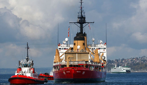 U.S. Coast Guard Cutter Polar Sea is towed stern-first into the Port of Seattle for major engine repairs, March 2004. (AP/Elaine Thompson)