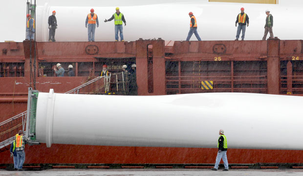 Workers unload one of three blades from a giant wind turbine on Monday, April 25, 2011, at the Port of Cleveland. (AP/Amy Sancetta)