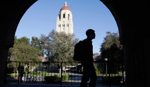 A Stanford University student walks in front of Hoover Tower on the Stanford University campus, 2012. (AP/Paul Sakuma)