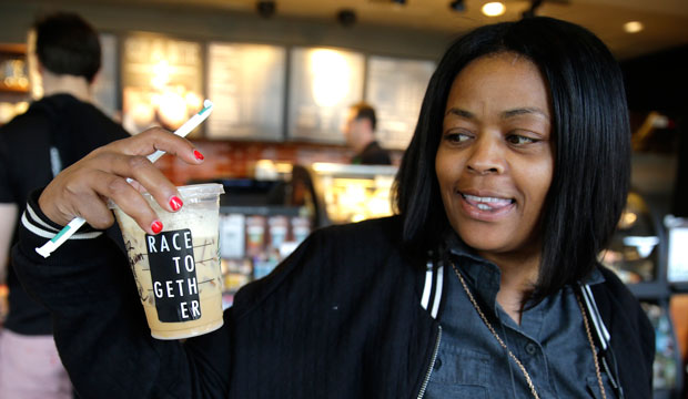 Larenda Myres holds an iced coffee drink with a