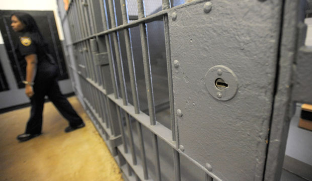 A corrections officer stands near a gate at Baltimore City Detention Center on November 14, 2013. (AP/Steve Ruark)