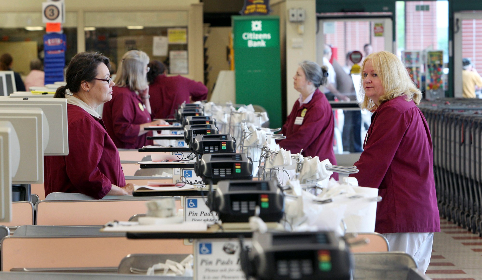 Cashiers and baggers stand idle Thursday, July 24, 2014 at a Market Basket supermarket in Concord, New Hampshire. (AP Photo)