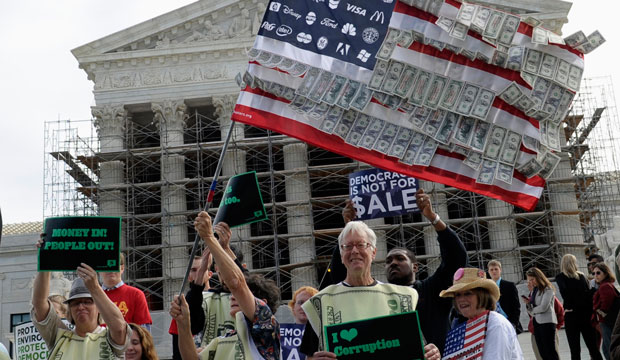 Demonstrators gather outside the Supreme Court in Washington, Tuesday, Oct. 8, 2013, as the court heard arguments on campaign finance. (AP/Susan Walsh)