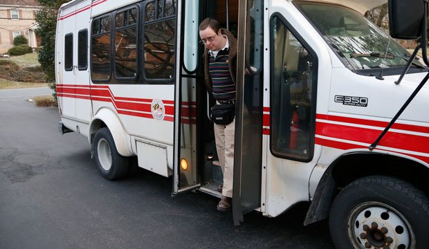 Matthew McMeekin gets off a bus at his home in Bethesda, Maryland, as he returns from work on February 10, 2014. (AP/Charles Dharapak)