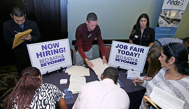 Job seekers fill out job applications at a Bed Bath & Beyond table at a job fair in Miami Lakes, Florida, October 2014. (AP/Alan Diaz)