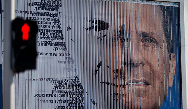 An election campaign billboard shifts between images of Isaac Herzog, leader of the Labor Party, right, and Israel's Prime Minister Benjamin Netanyahu, leader of the Likud Party, in Tel Aviv, Israel, March 5, 2015. (AP/Ariel Schalit)