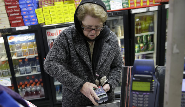 Hilda Herrera pays for her groceries using a nutrition assistance program at a supermarket in West New York, New Jersey. (AP/Seth Wenig)