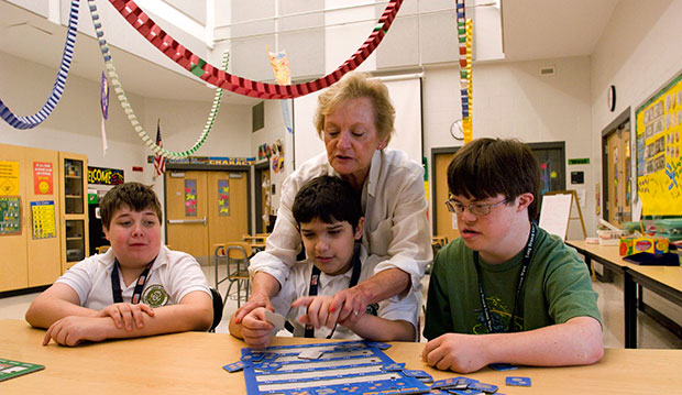 Special-education teacher Karen Hansen works with students during a money-counting exercise in a 6-8 grade class at Long Branch Middle School in Long Branch, New Jersey, June 2007. (AP/Colin Archer)