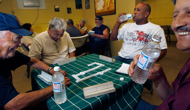 Residents play dominos at the Riverview Senior Center in Springfield, Massachusetts, a designated cooling center for people seeking relief from the hot weather, on June 9, 2011. (AP/Elise Amendola)