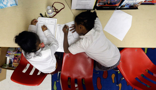 A pair of students work in a classroom at John Eager Howard Elementary School in Baltimore on April 30, 2013. (AP/Patrick Semansky)