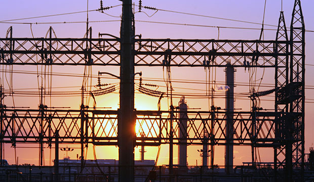 The sun sets behind an electrical power substation in Elizabeth, New Jersey, August 23, 2005. (AP/Mel Evans)