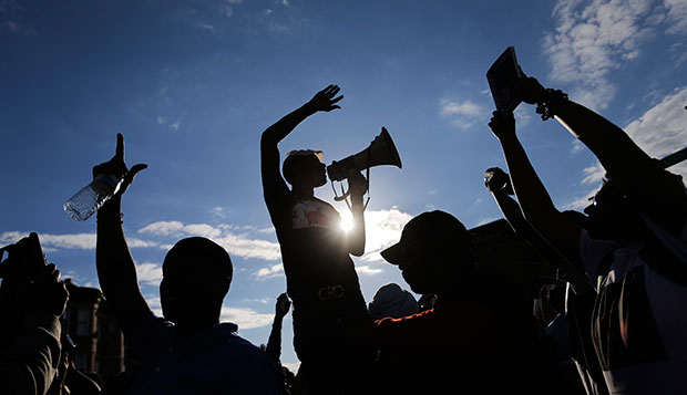 Demonstrators cheer in the intersection of West North and Pennsylvania avenues in Baltimore on May 2, 2015, one of the sites of that week's rioting, as they march a day after charges were announced against the police officers involved in Freddie Gray's death. (AP/David Goldman)