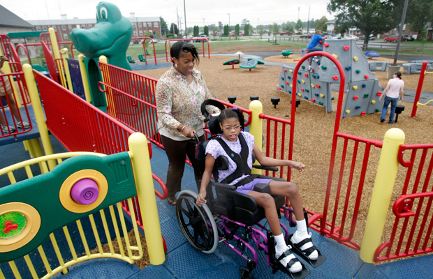 Melissa Nelson takes her daughter to the Boundless Playground at Fort Campbell, Kentucky. The playground is specially designed for both parents and children with disabilities. (AP/Mark Humphrey)