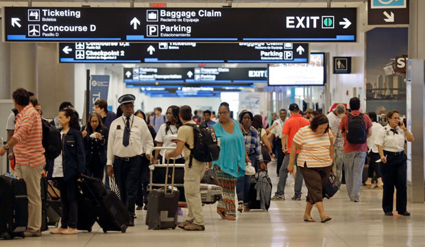 Travelers walk down the halls at Miami International Airport in Miami on Friday, May 22, 2015. (AP/Alan Diaz)