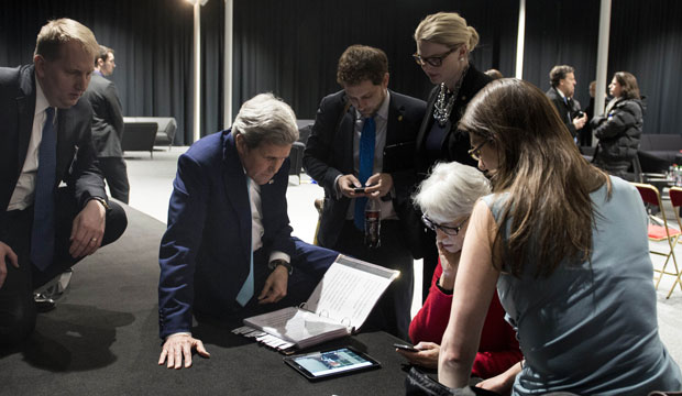 U.S. Secretary of State John Kerry watches President Barack Obama speak via tablet in Lausanne, Switzerland, on April 2, 2015, after Iran nuclear program talks finished. (AP/Brendan Smialowski)
