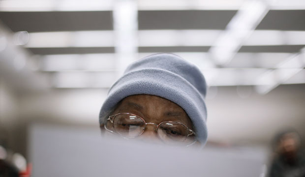 Frazzia Preston reads paperwork while waiting for her case to be heard to avoid foreclosure from tax debts in Detroit on January 29, 2015. (AP/Paul Sancya)