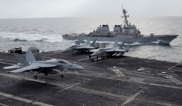 A U.S. F-18 fighter jet lands on the aircraft carrier USS Abraham Lincoln during fly exercises in the Gulf on February 13, 2012. (AP/Hassan Ammar)