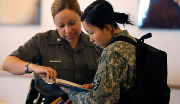 New York State Trooper Maxine Mendez, left, speaks to Xiaojiao Zuo about employment opportunities during a U.S. Chamber of Commerce jobs expo in New York on June 30, 2015. (AP/Mary Altaffer)