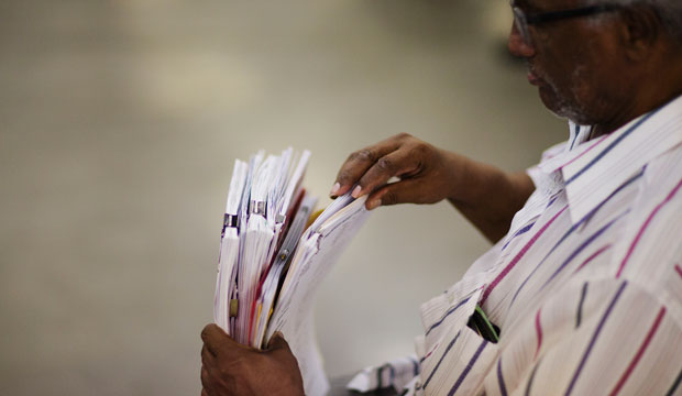 A man holds paperwork as he attempts to apply for a home loan in Atlanta, Georgia, on September 30, 2014. (AP/David Goldman)